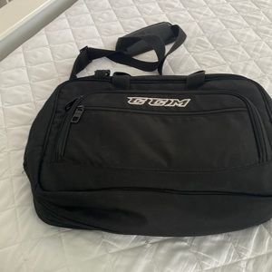 Expandable bag. Multiple zippered pockets with a shoulder strap. Black canvas.